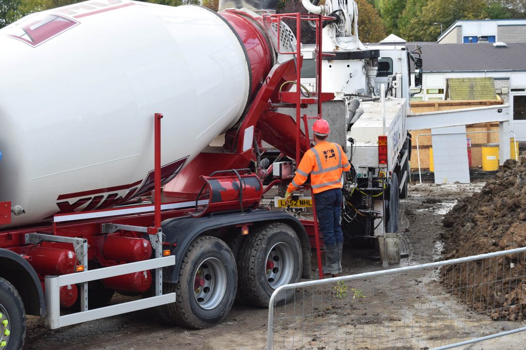 worker using concrete truck controls